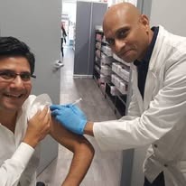 A professional pharmacist at Whole Health Glebe administering a vaccine